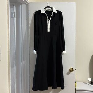 Black midi dress with white collar.